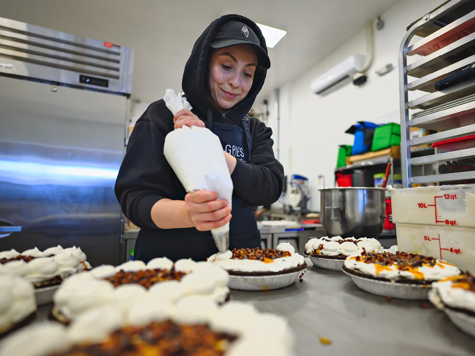 Magpies team putting whip cream on pie