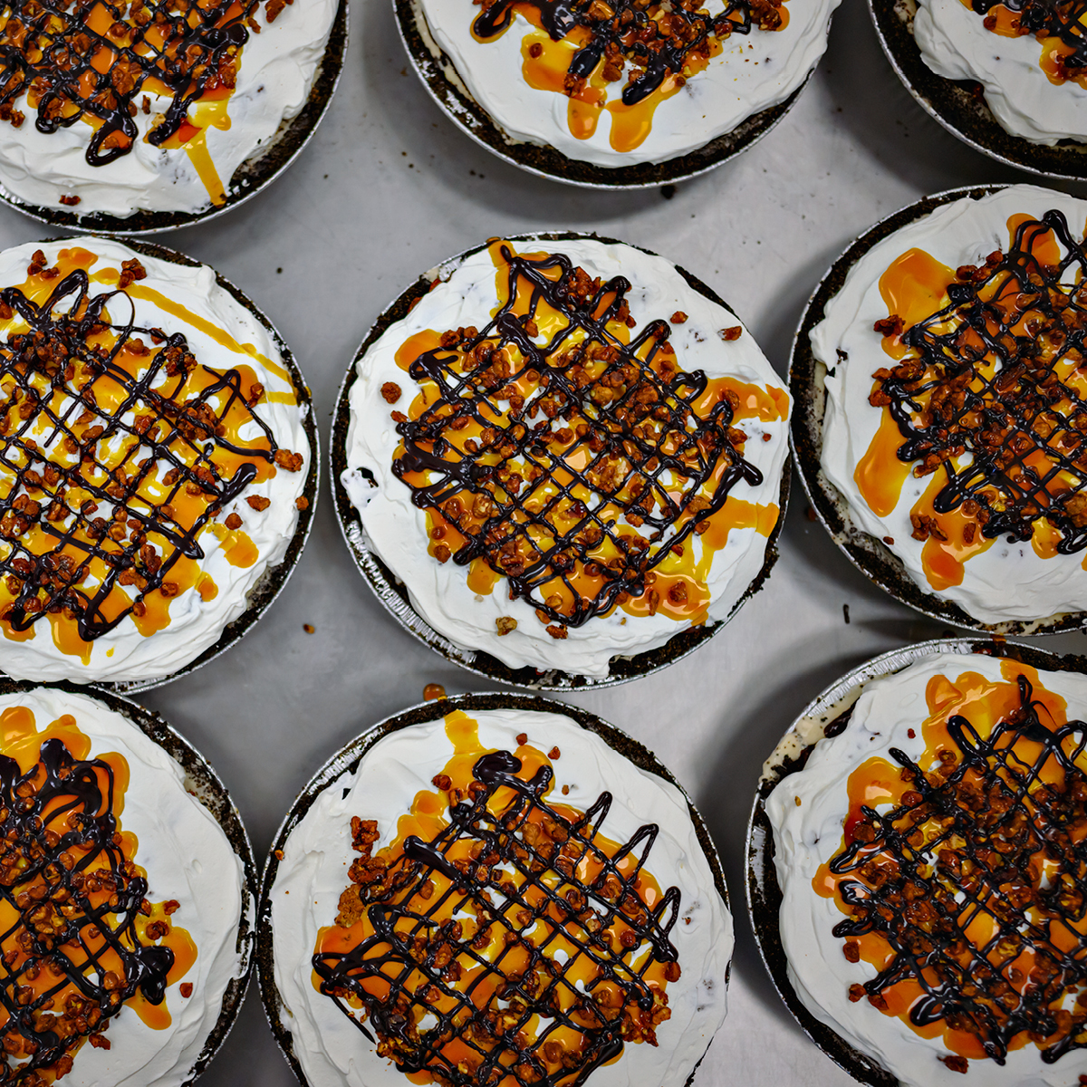Multiple soft serve pies with caramel drizzle and crumb topping